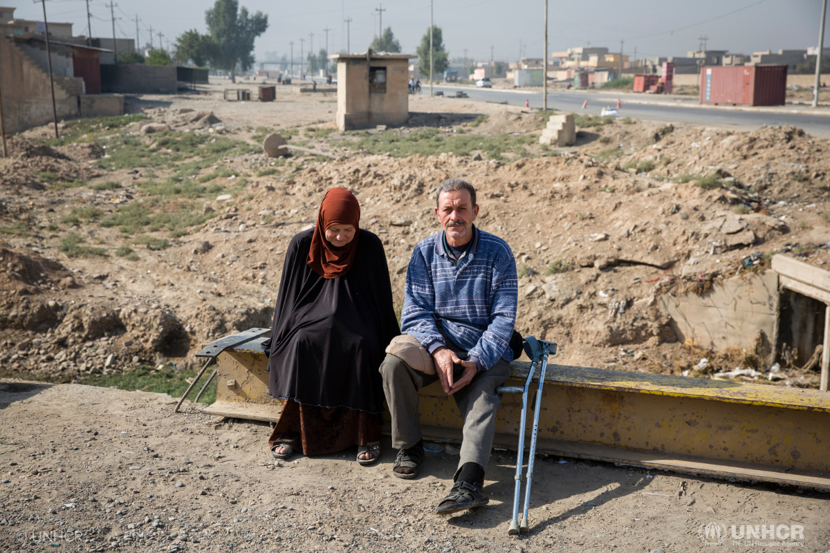 brother and sister sitting outside road