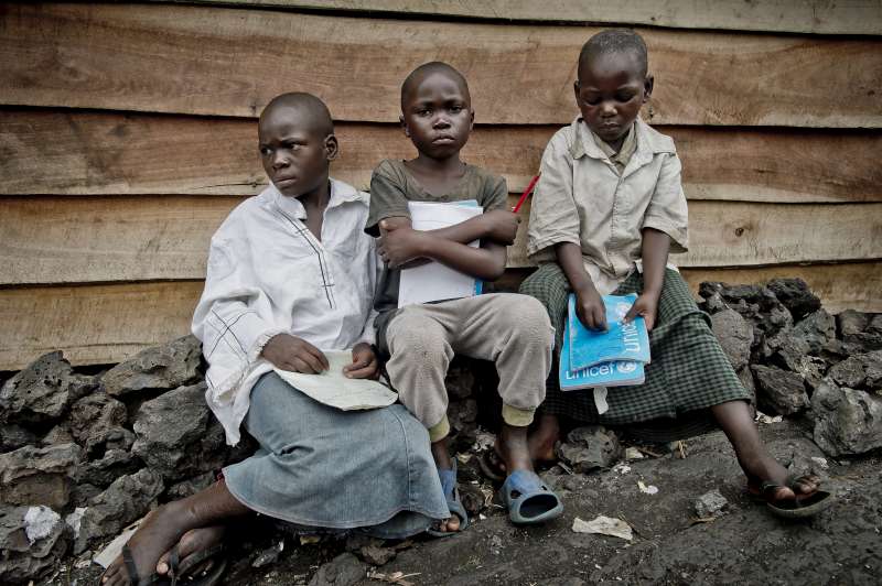 Sukuru (center) is longing to go back to school, which has been closed since the fighting began in mid-November.