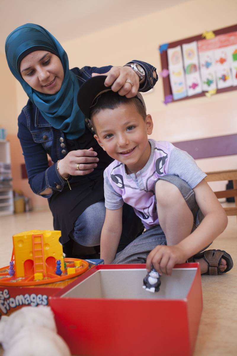 Majid, an English teacher back in Syria, shares her son’s joy at the toy distribution in Nizip-2 camp.