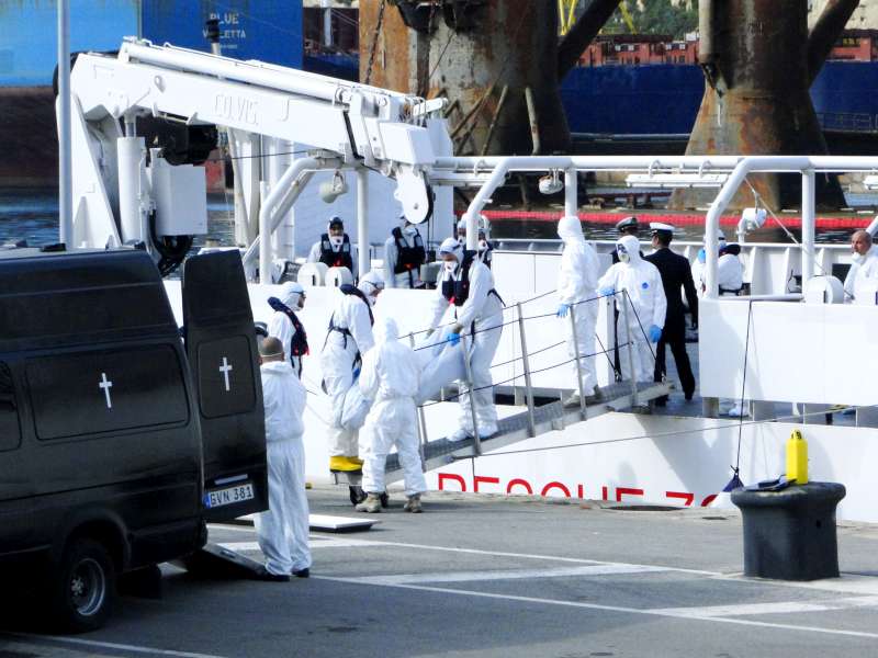 Maltese emergency workers in Senglea this morning collect bodies from the Mediterranean disaster at the weekend.