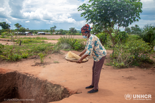 Farmer Mama Antho cleans rice from her farm.