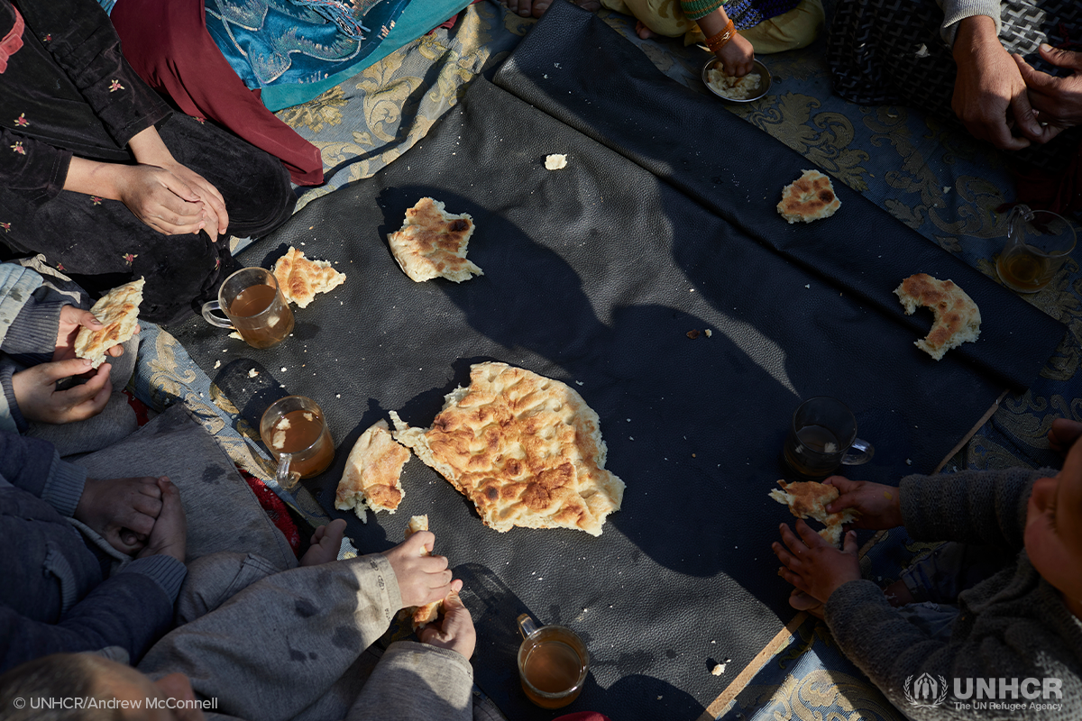 several people sharing a large piece of bread