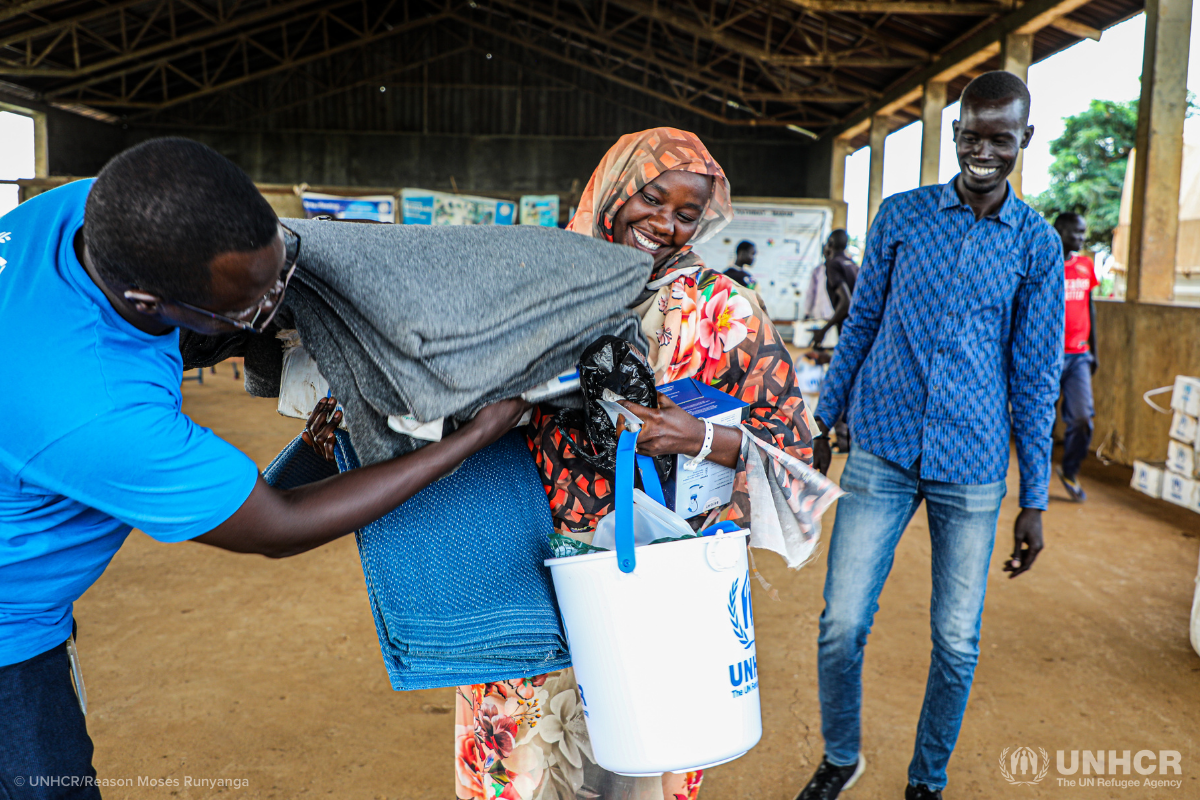 Refugee receiving supplies from UNHCR