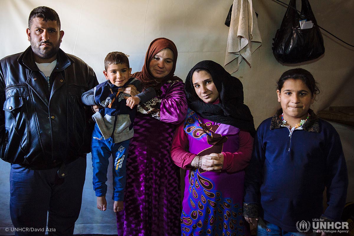 From left, Syrian refugees Khaled, 35, Yehya, 3, Najaf, 41, Nadia, 12, and Nawfa, 11, pose for a photograph in their shelter at an informal settlement near Terbol in the Bekaa Valley