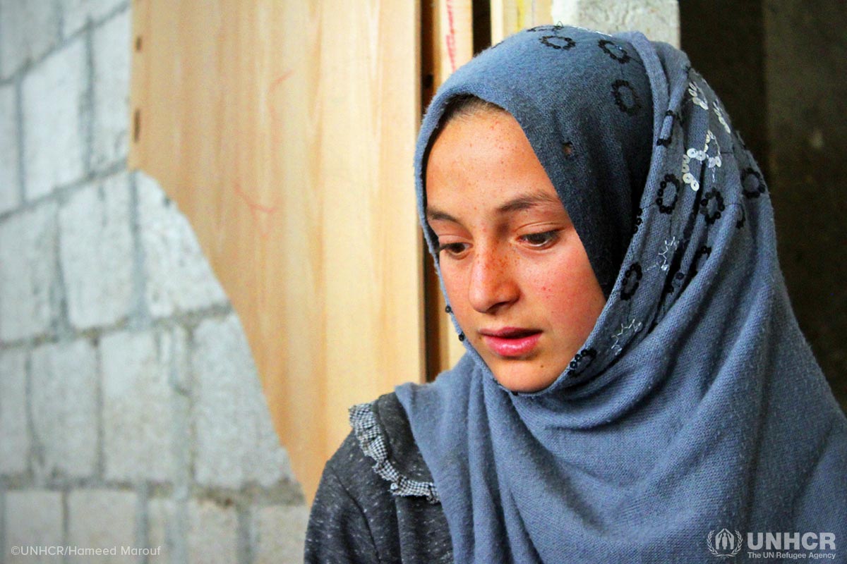 Internally displaced Syrian girl, Asmaa, 12, is happy to be back at school in Jibreen collective shelter in Aleppo