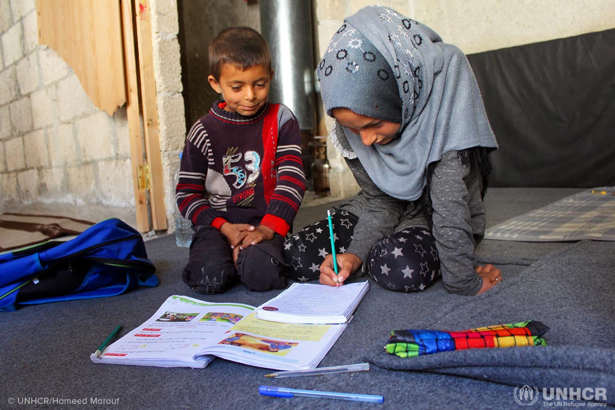 Internally displaced Syrian girl, Asmaa, 12, and her brother Ali, 8, are happy to be back at school in Jibreen collective shelter, Aleppo where they are living with their parents.