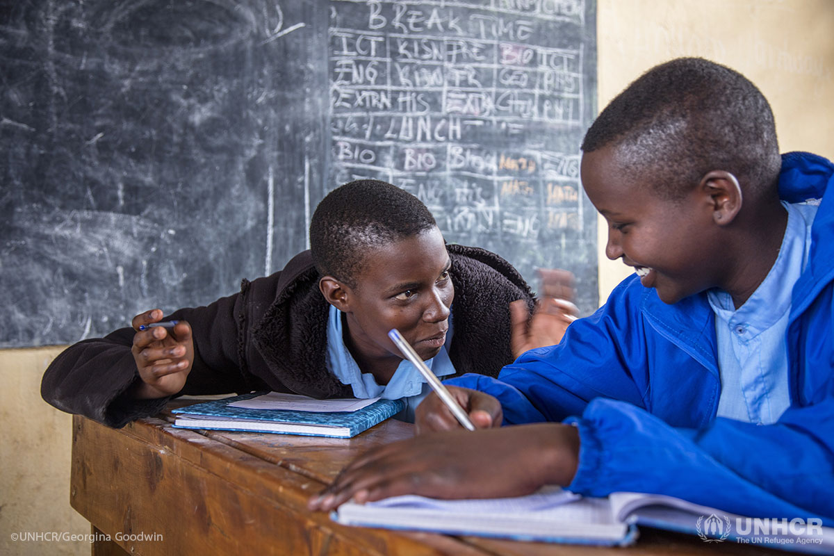 Anethe Cyuzuzo (in blue coat), 15, is from Rwanda and Irikungoma Bellaca (black coat), 16, comes from Burundi. The two girls are best friends at Paysannat L school, in Mahama refugee camp, Kirehe, eastern Rwanda.