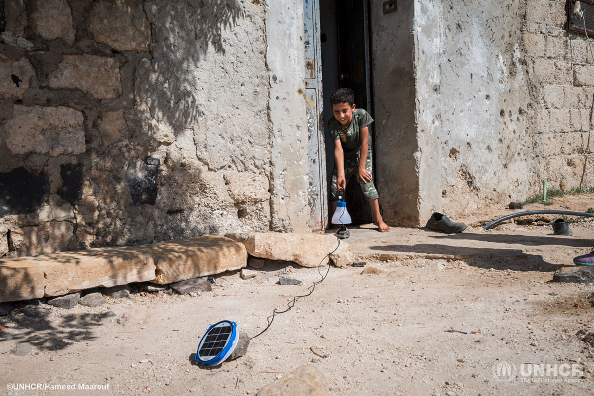 Moayyed installing the solar light his family received.