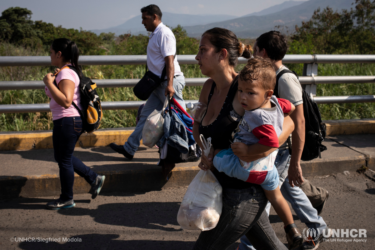 Venezuelans crossing bridge