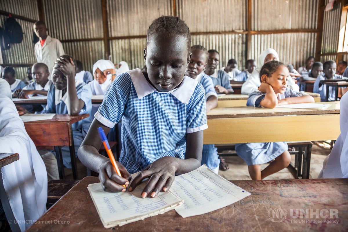 school girl sitting at desk, school supplies