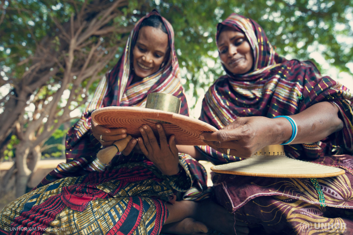 fatouma and adizata work together to weave a basket