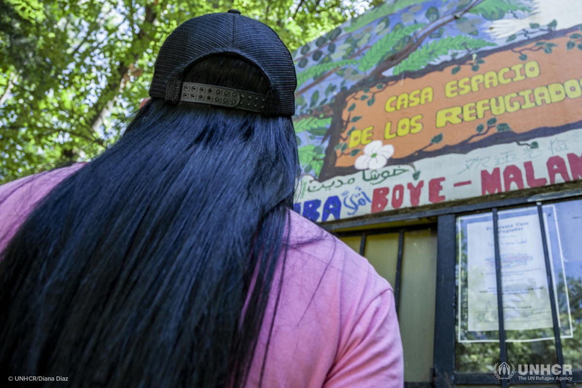 estefania looks up at a sign