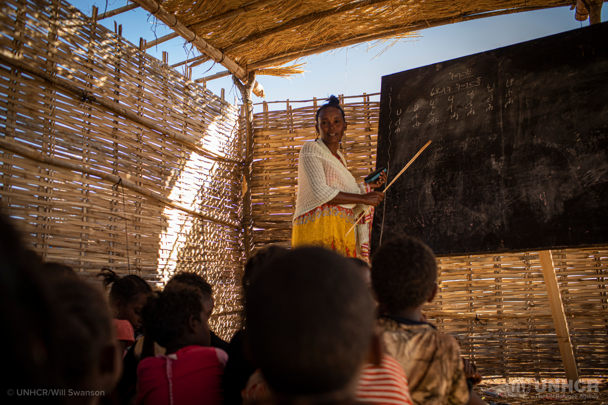 Volunteer teacher and Ethiopian students at learning center in Sudan