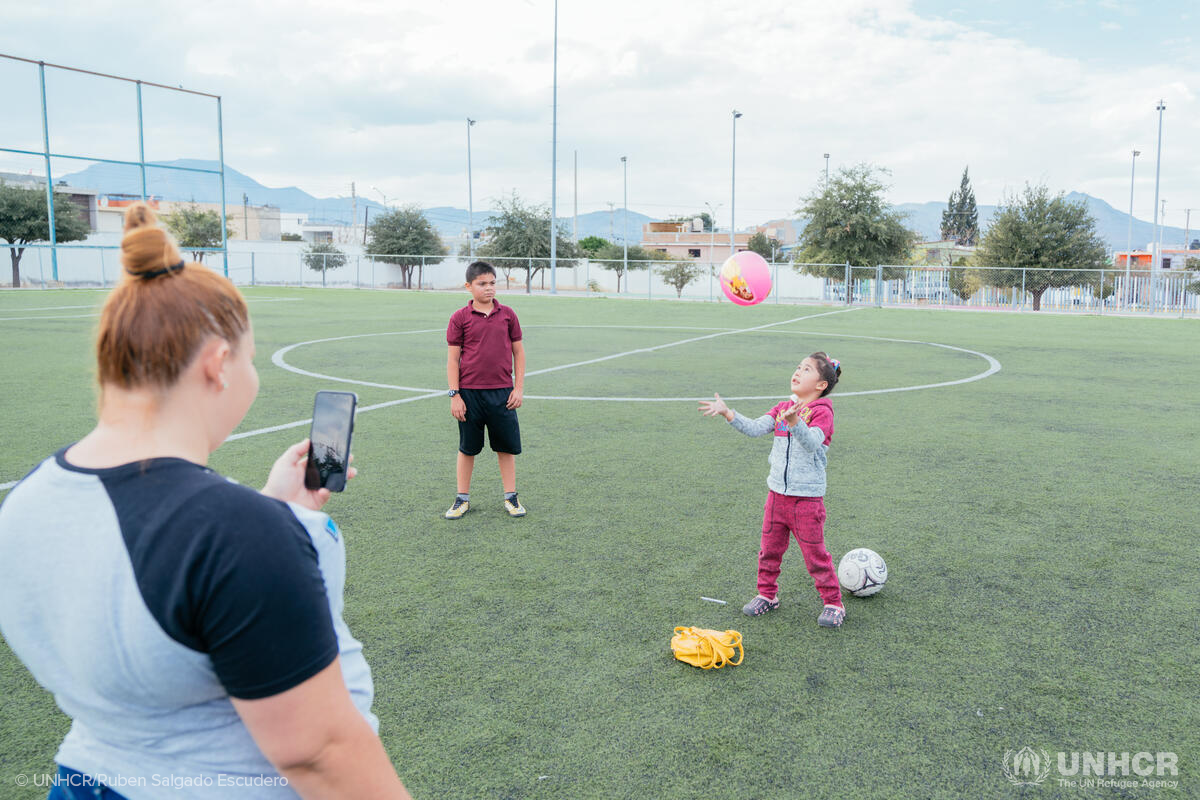 dania overseeing children playing soccer