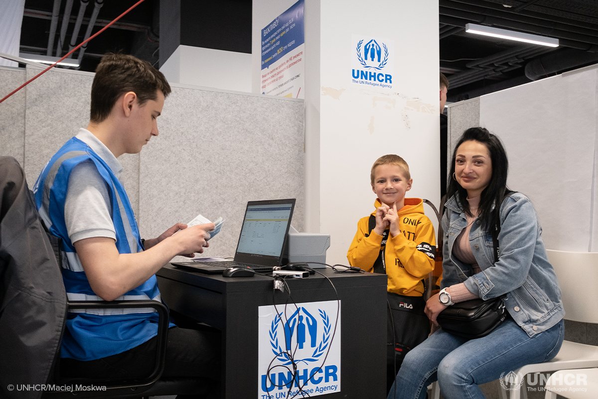 mother and son in Poland receiving cash assistance