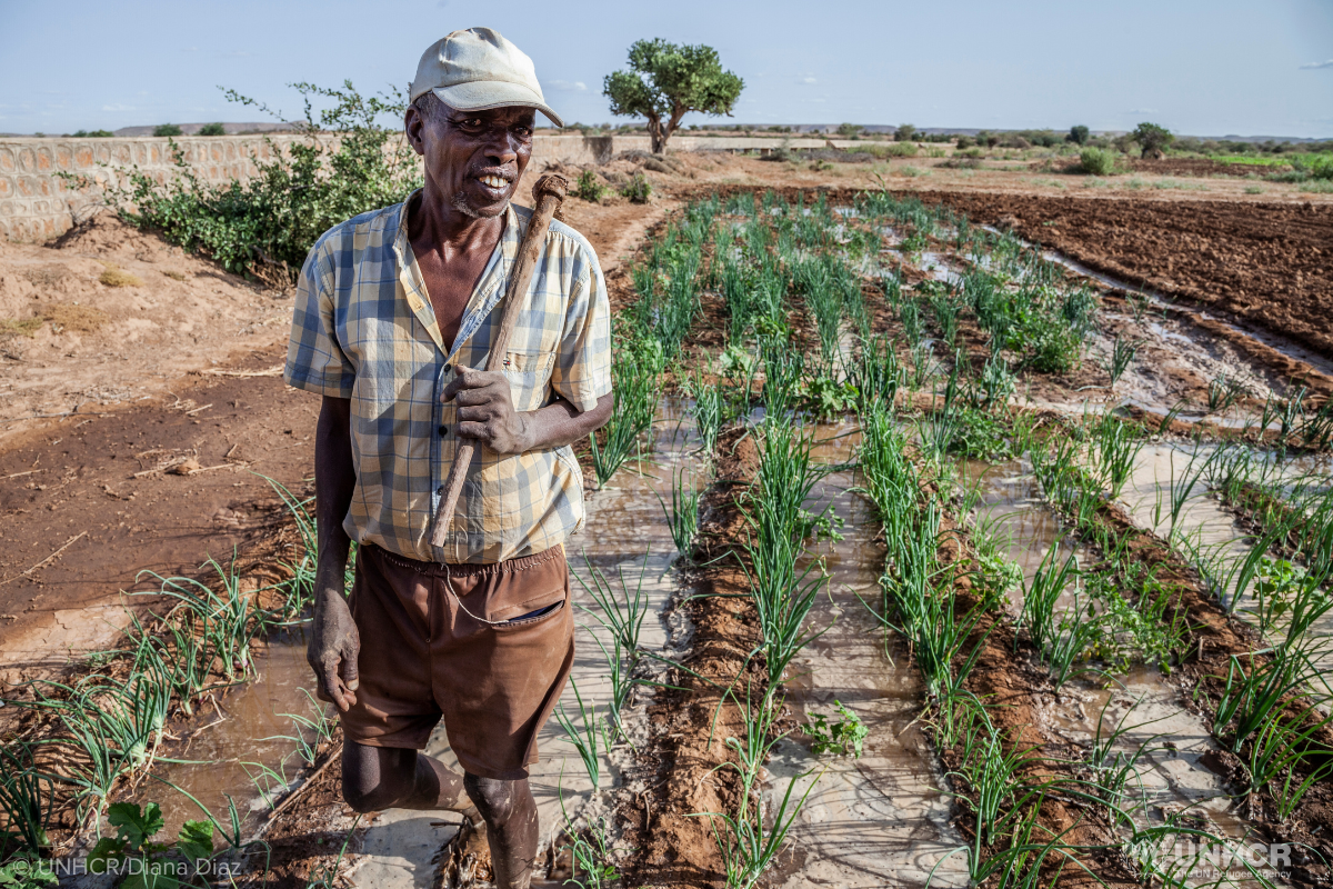 Somali Refugee holding a farming tool