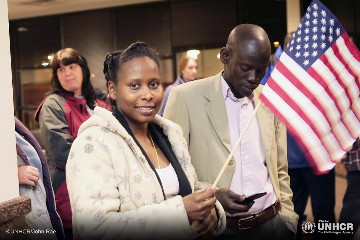 Resettled refugee holding the American flag.