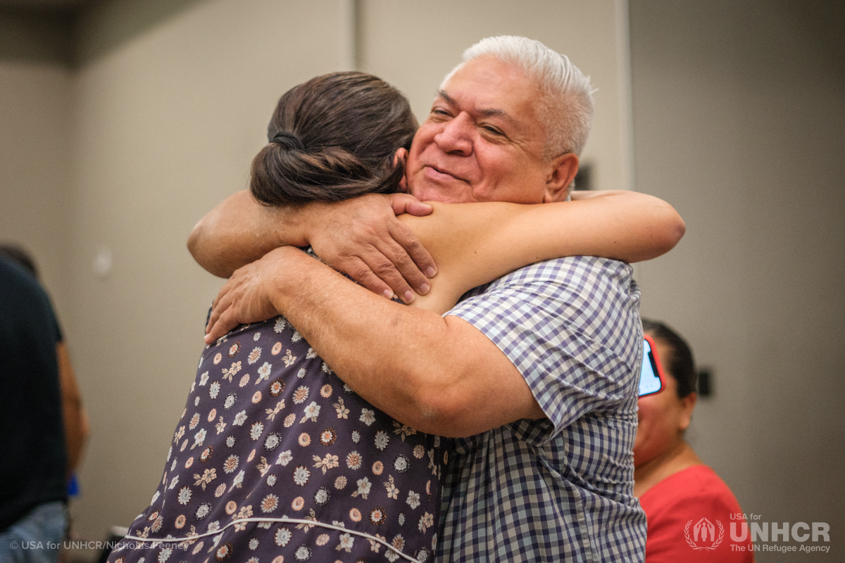 Paola Monroy (left) meets with a refugee at a community meeting in Leon, Mexico