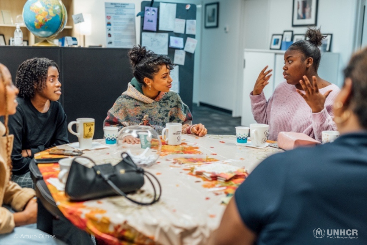 Liza listens to Beatrice, a refugee from the Democratic Republic of the Congo, tell her story.