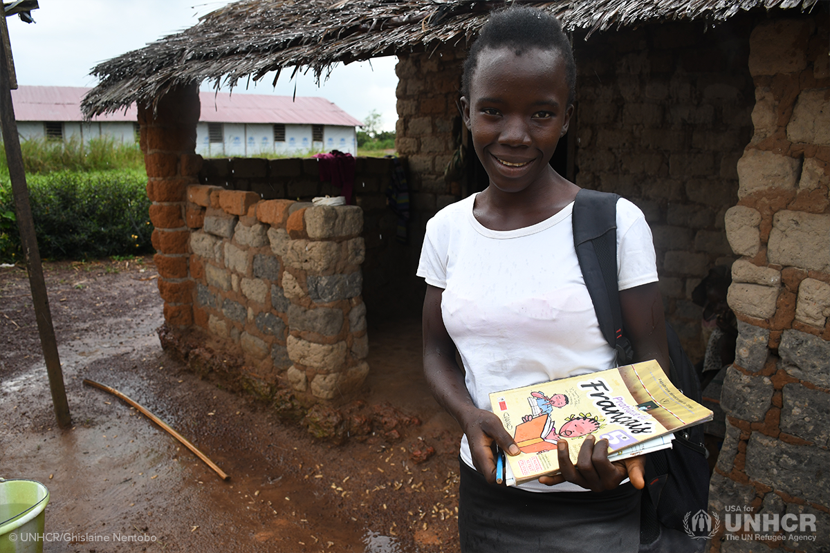 angele smiles outside her open air classroom