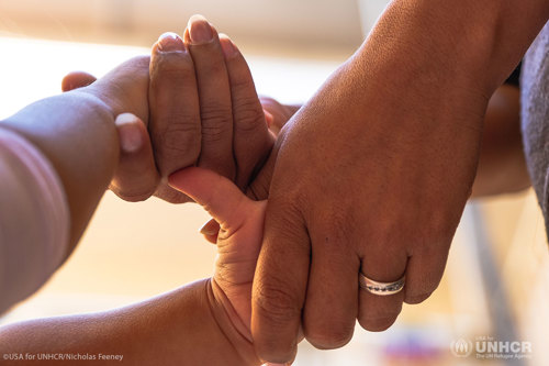 Mother and child holding hands.