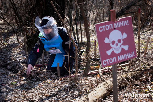 Tetiana Nikoforva, 37, searches for landmines with a team from the HALO Trust, near Ozerne, Donbas, Ukraine. Her brother-in-law was killed by a mine when a shell exploded next to him.