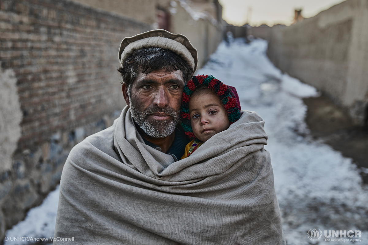 Rehman Gul with his two year old daughter near their home on the outskirts of Kabul