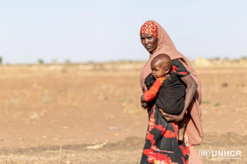 A mother carries her child through the parched landscape of Ethiopia’s Somali region, where thousands of families have been displaced during a recent drought.