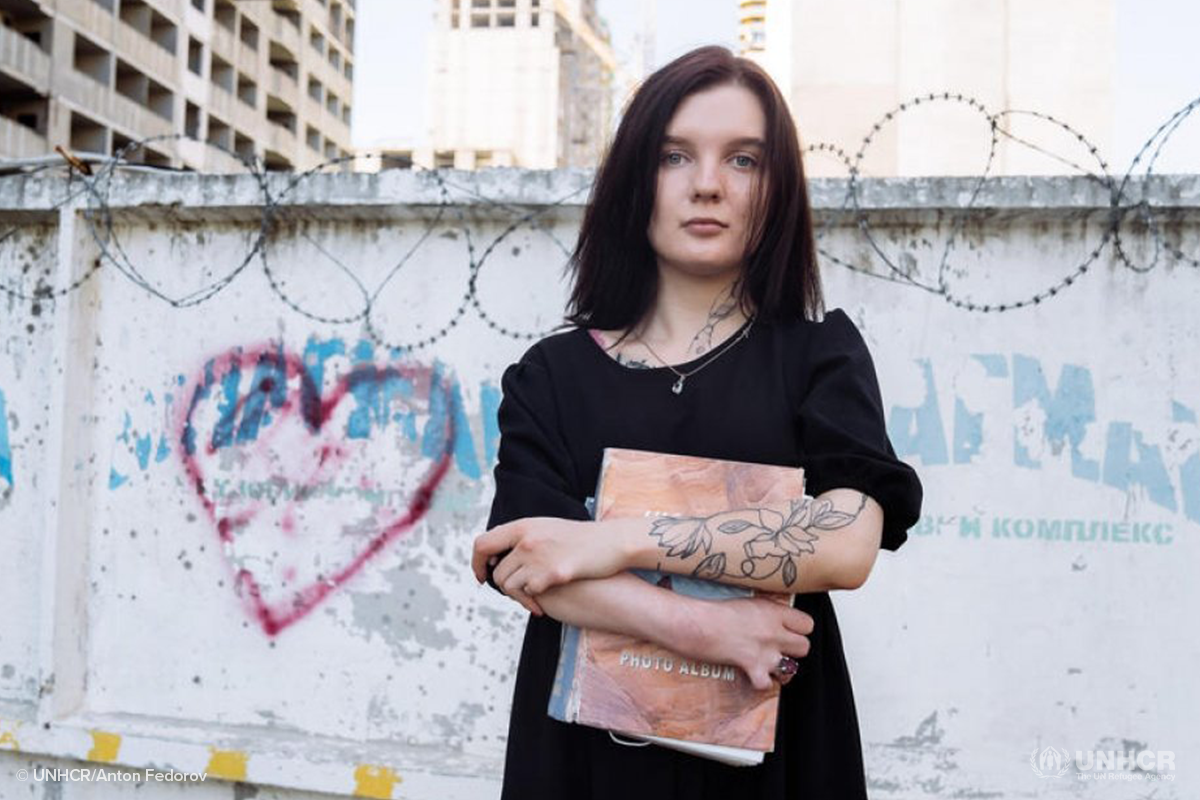 Anna Miryasheva, a 22-year-old stateless woman from Kyiv in Ukraine, holds a photo album containing pictures of her late mother, Olena