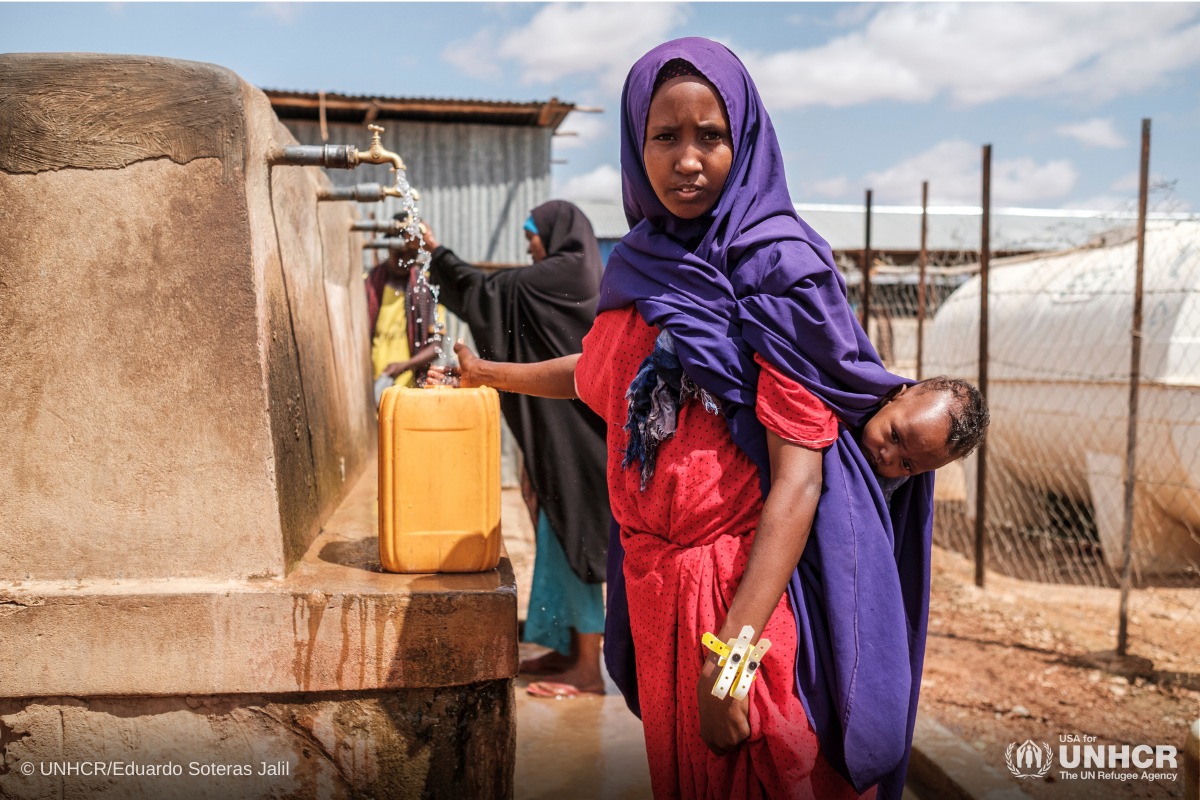 A Somali mother fills a jerrycan at UNHCR's reception center in Dollo Ado, Ethiopia