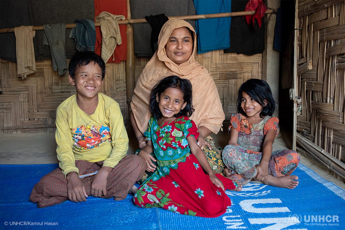 portrait of Hussein Banu smiling with her children