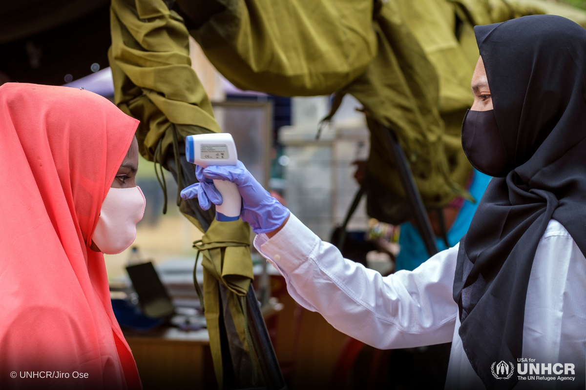 Rohingya refugee in Indonesia getting temperature checked