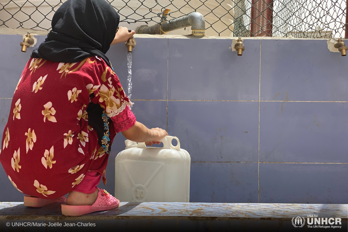 A young Yemeni girl fetches water at the communal water source in a site for internally displaced persons in Marib in Yemen