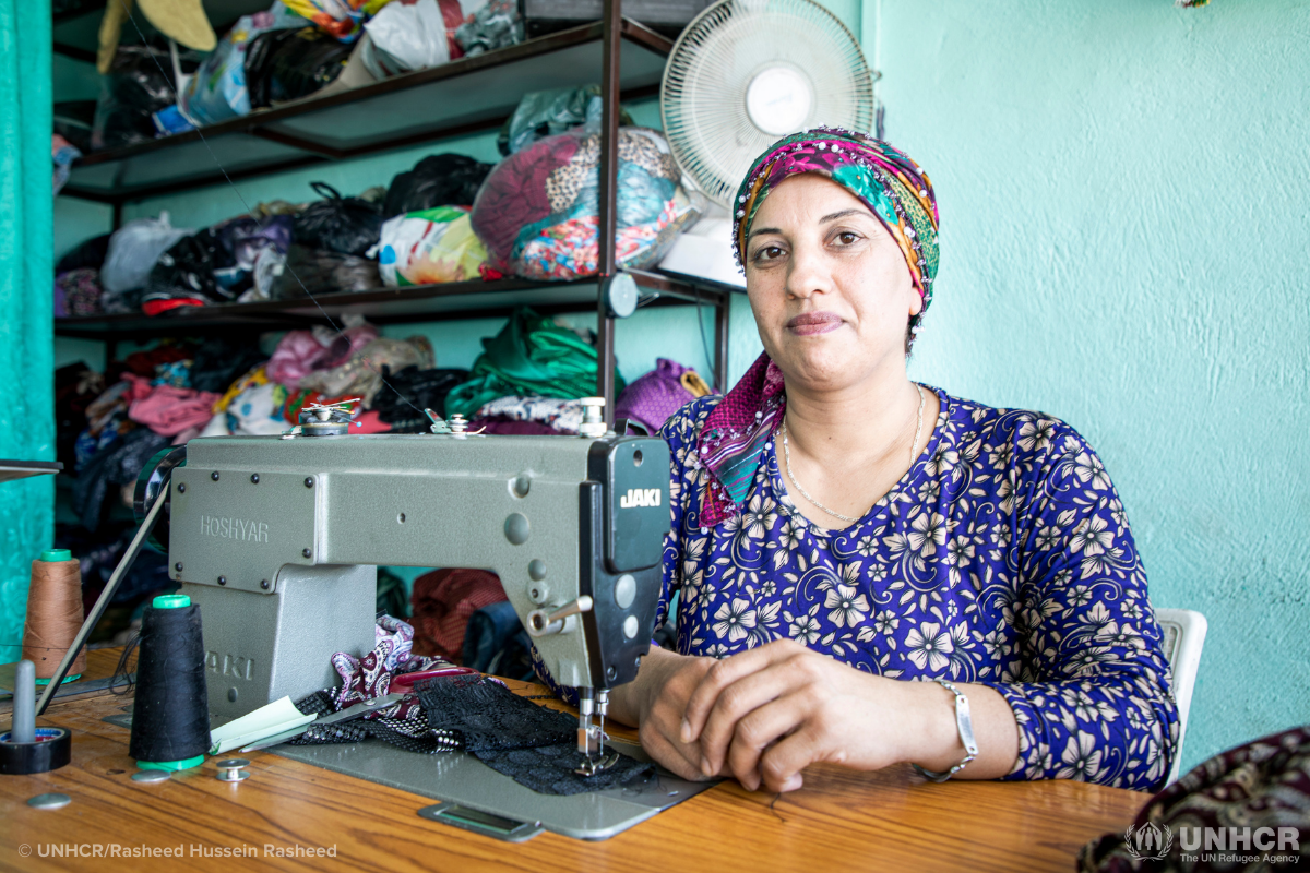 Amina working at her sewing machine