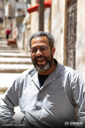 Syrian refugee, Abdelwahed, or Abu Bilal as he is otherwise known, sits outside his apartment in Amman during Ramadan.