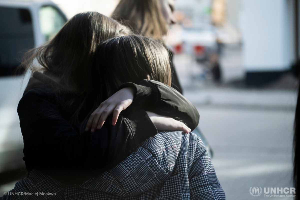 Displaced people from Ukraine hug