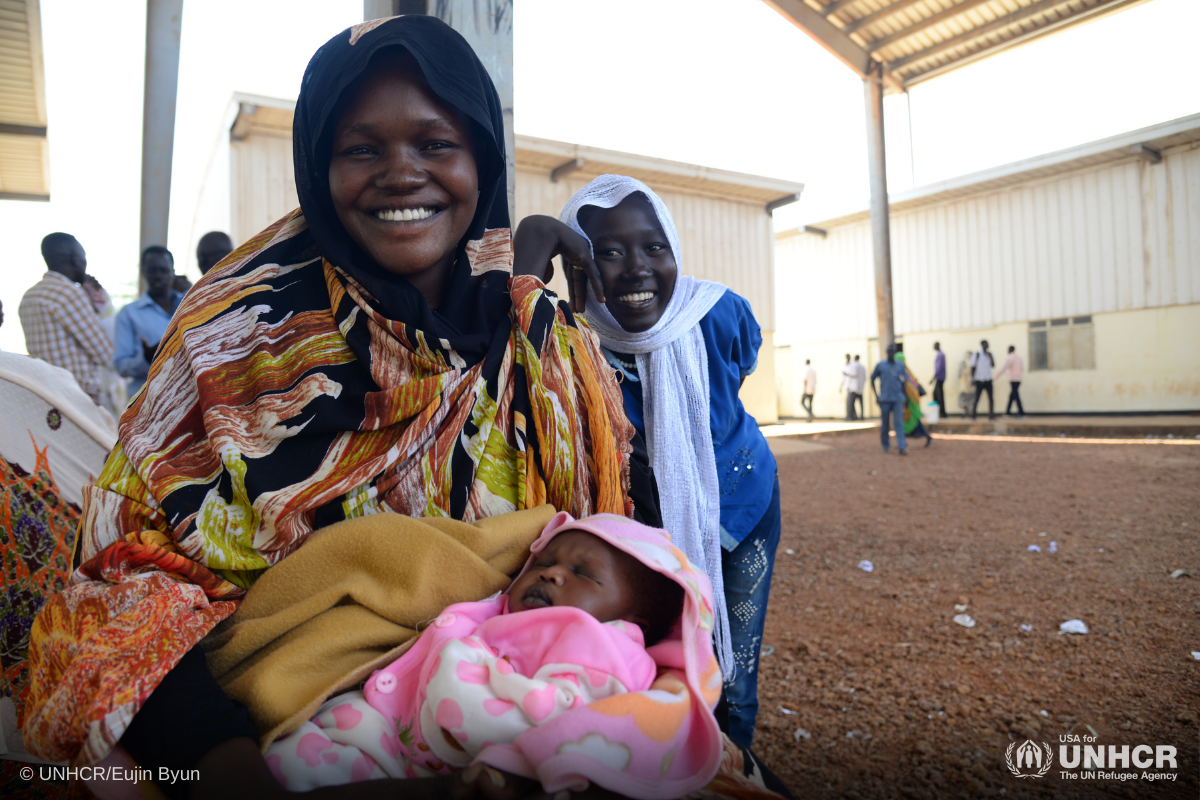 smiling mother holding child