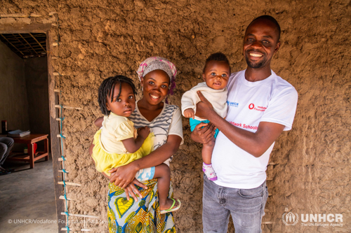 Pascal with his family in front of their home.