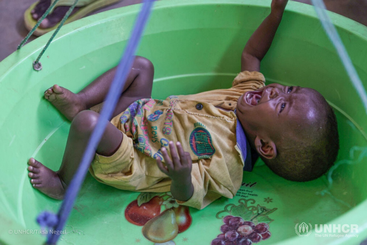 Samira's son is weighed at the nutrition center