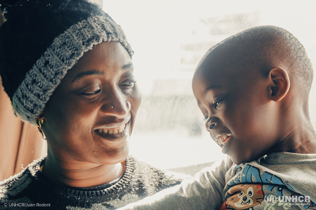 refugee mother smiles at her son