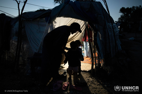 Night falls over the refugees and migrants in makeshift shelters and tents in an olive grove next to Moria reception center on Lesvos.