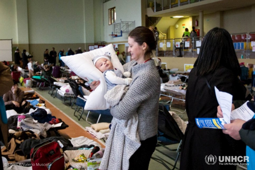 Valentina from Kharkiv in northeastern Ukraine cradles her baby nephew Andrii in a reception centre in the Polish border town of Medyka.