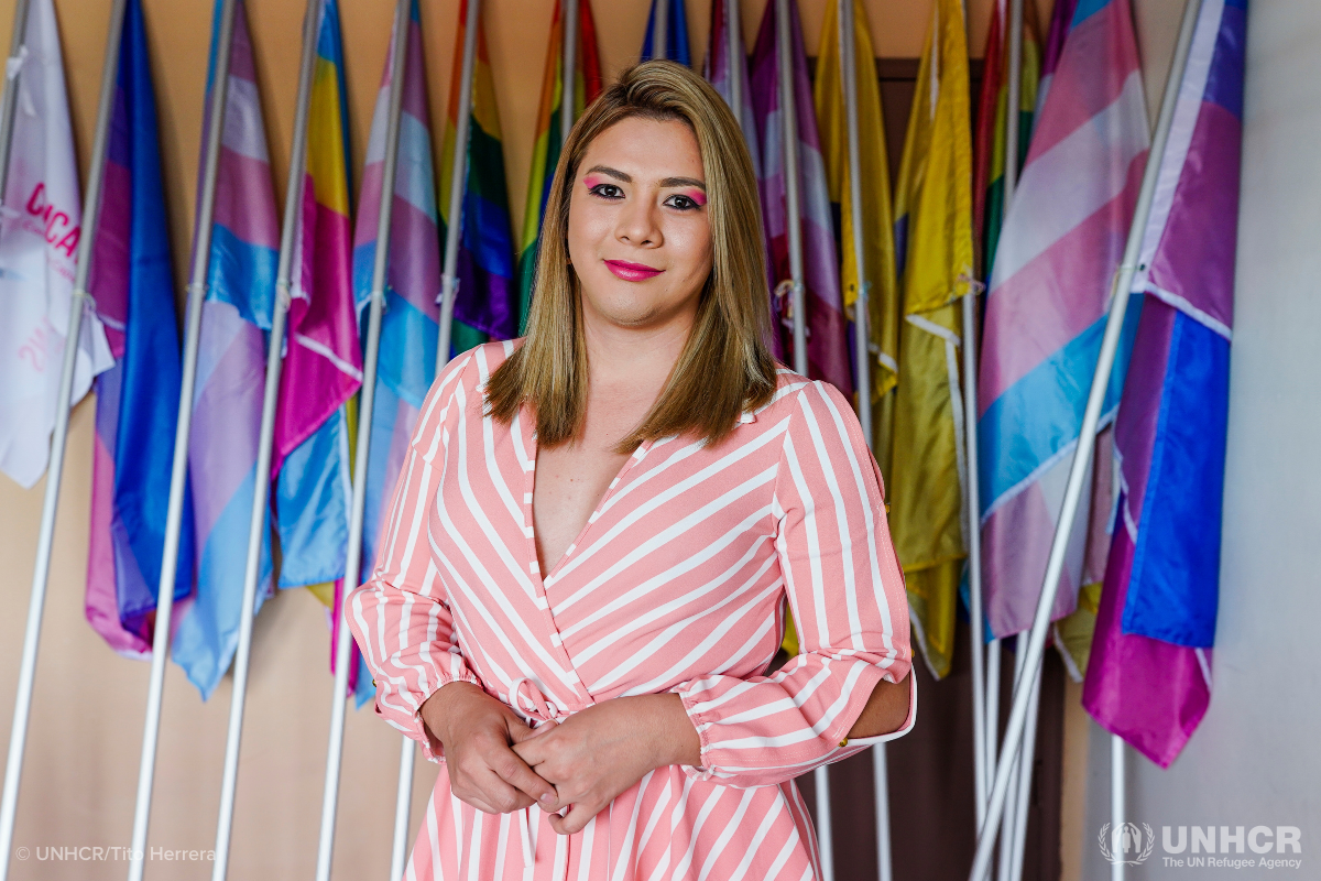 Bianka Rodríguez standing in front of flags