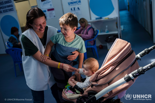 Viktoria holds her son Evgeny and looks over her 7-month old neice in a stroller.