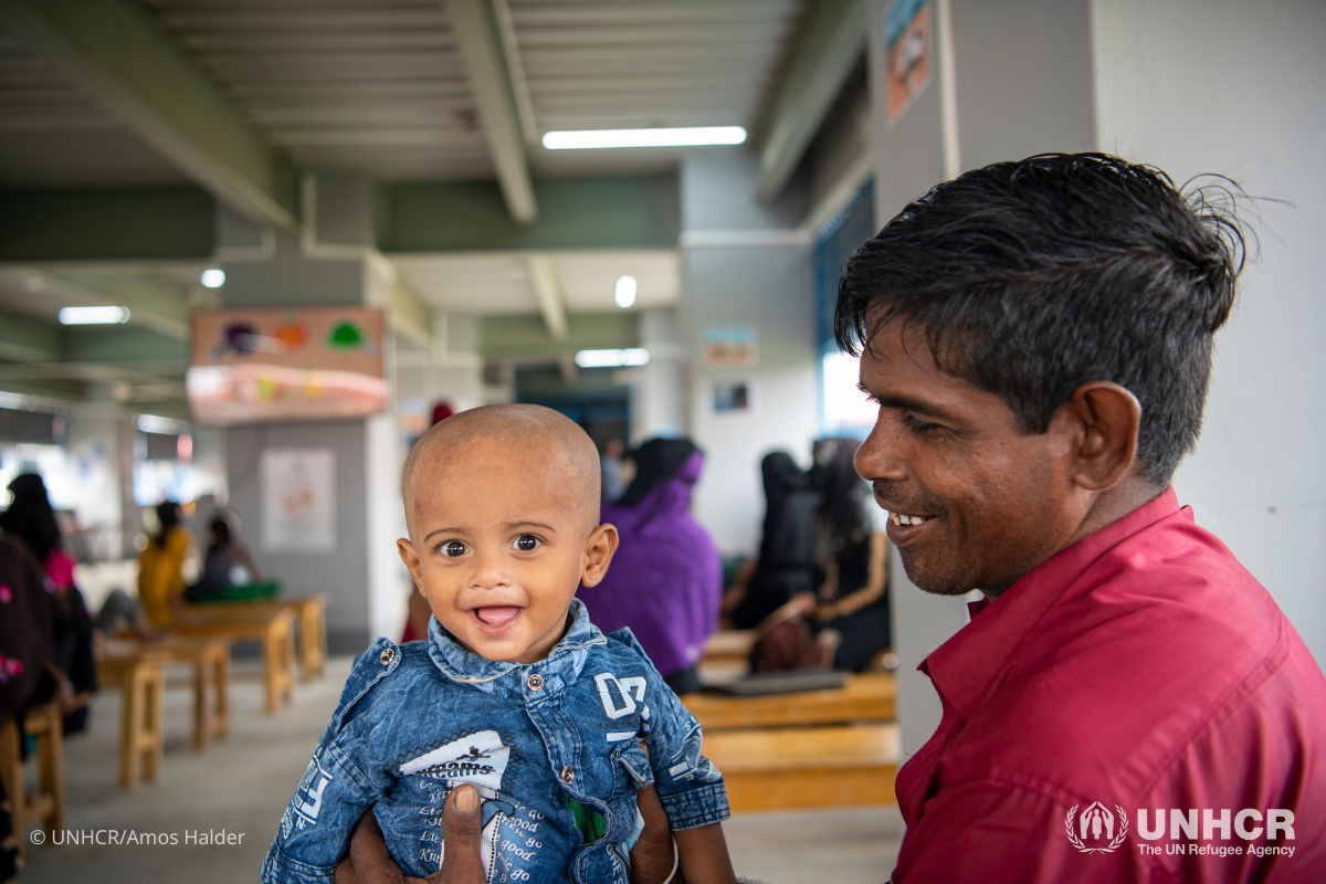 Abdul Amin brings his son to the Bhasan Char registration center