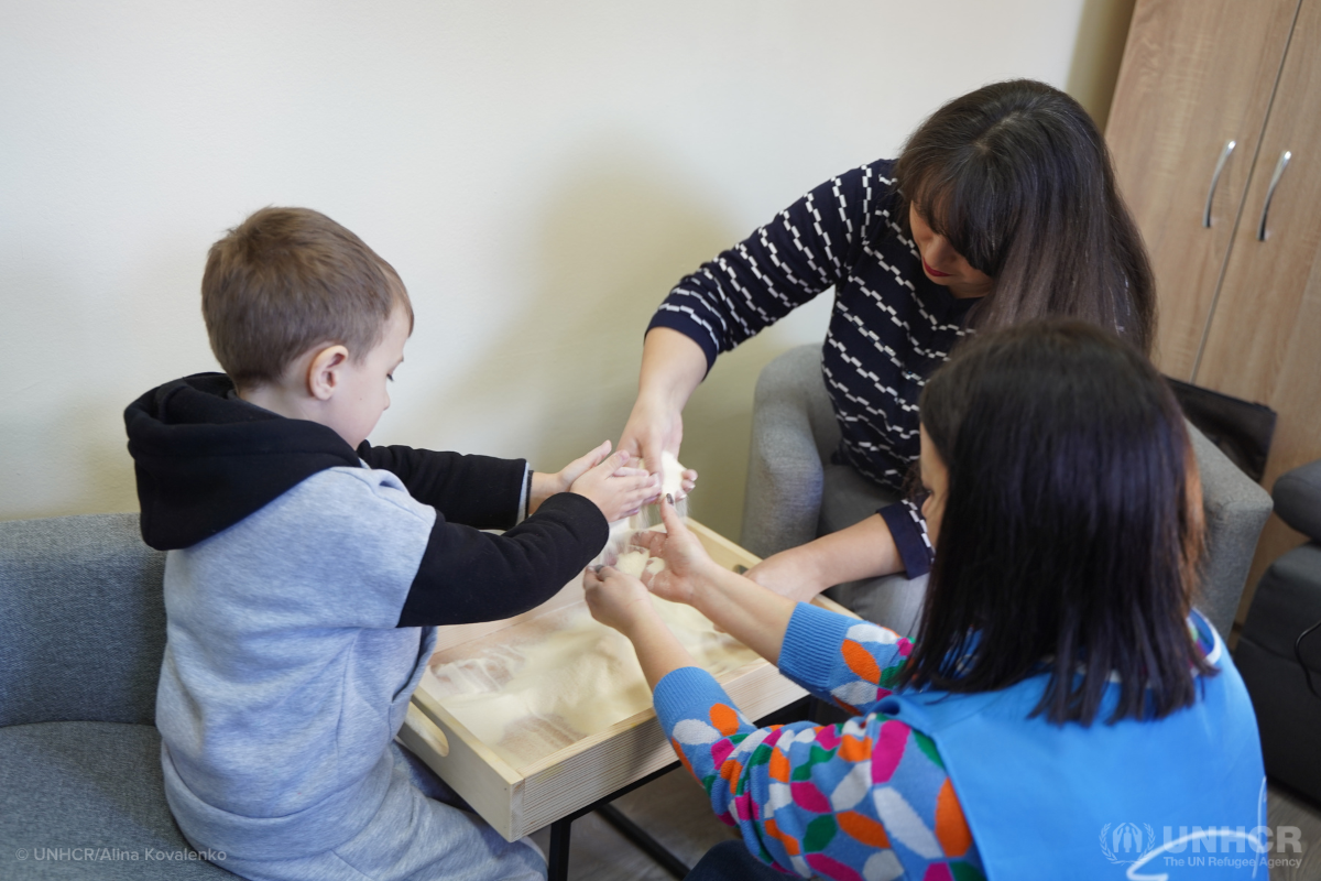 Ukrainian mother Olena and her son doing art therapy