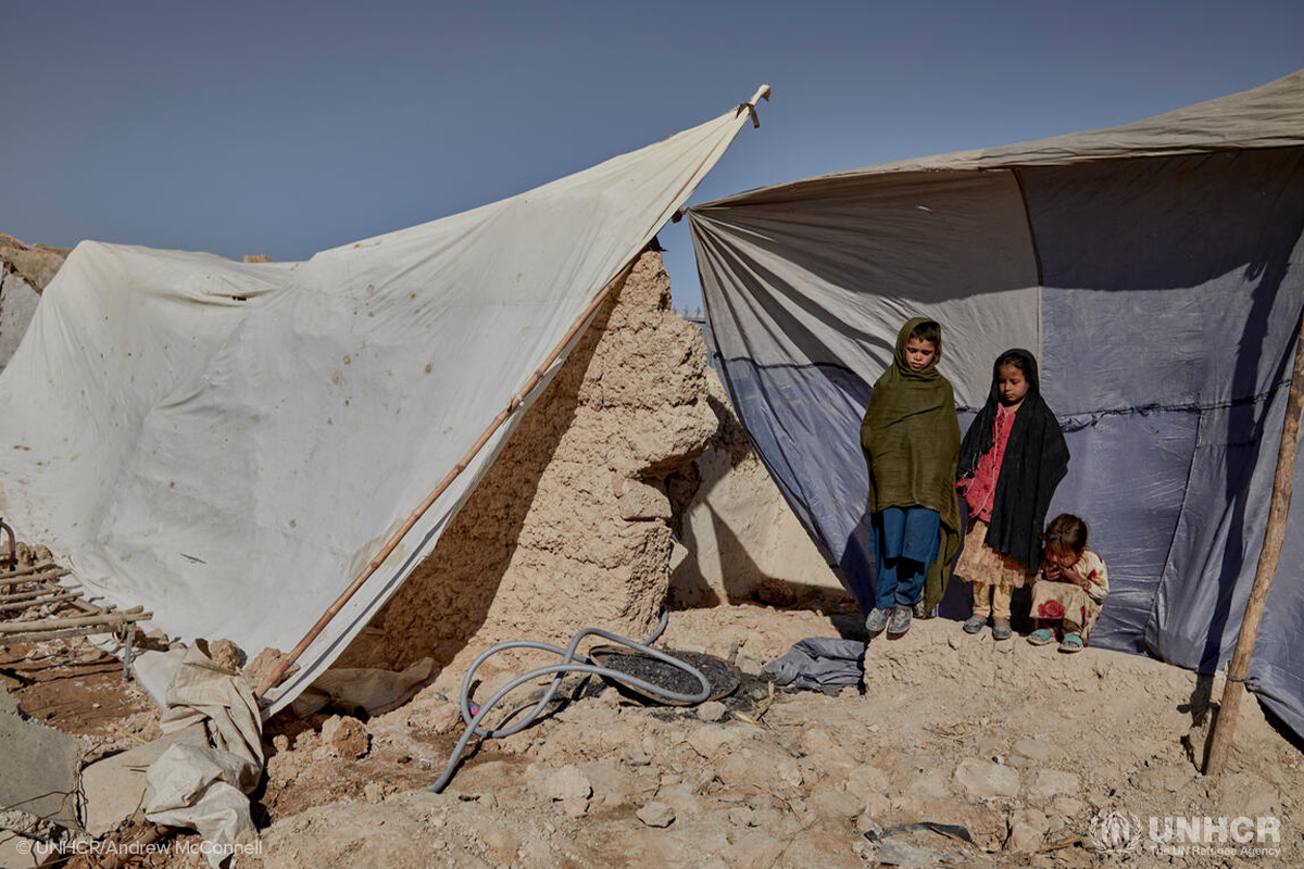 Children shelter in what remains of their family home in the Bolan area of Helmand, near Lashkar Gah city