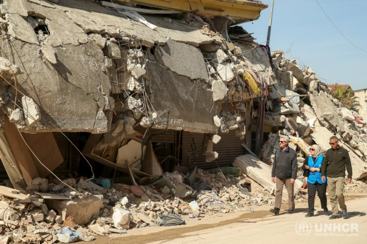 UN High Commissioner for Refugees Filippo Grandi (left) walks in front of destroyed buildings in Hatay, Türkiye, during a three-day visit to the country in March.