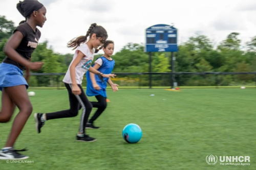 Siblings Ziba and Noor playing a soccer game