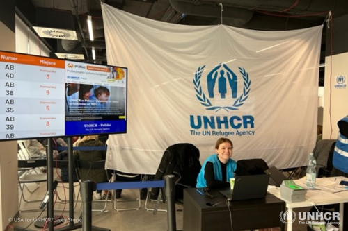 Registration table at a UNHCR-led Blue Dot Center in Warsaw, Poland.